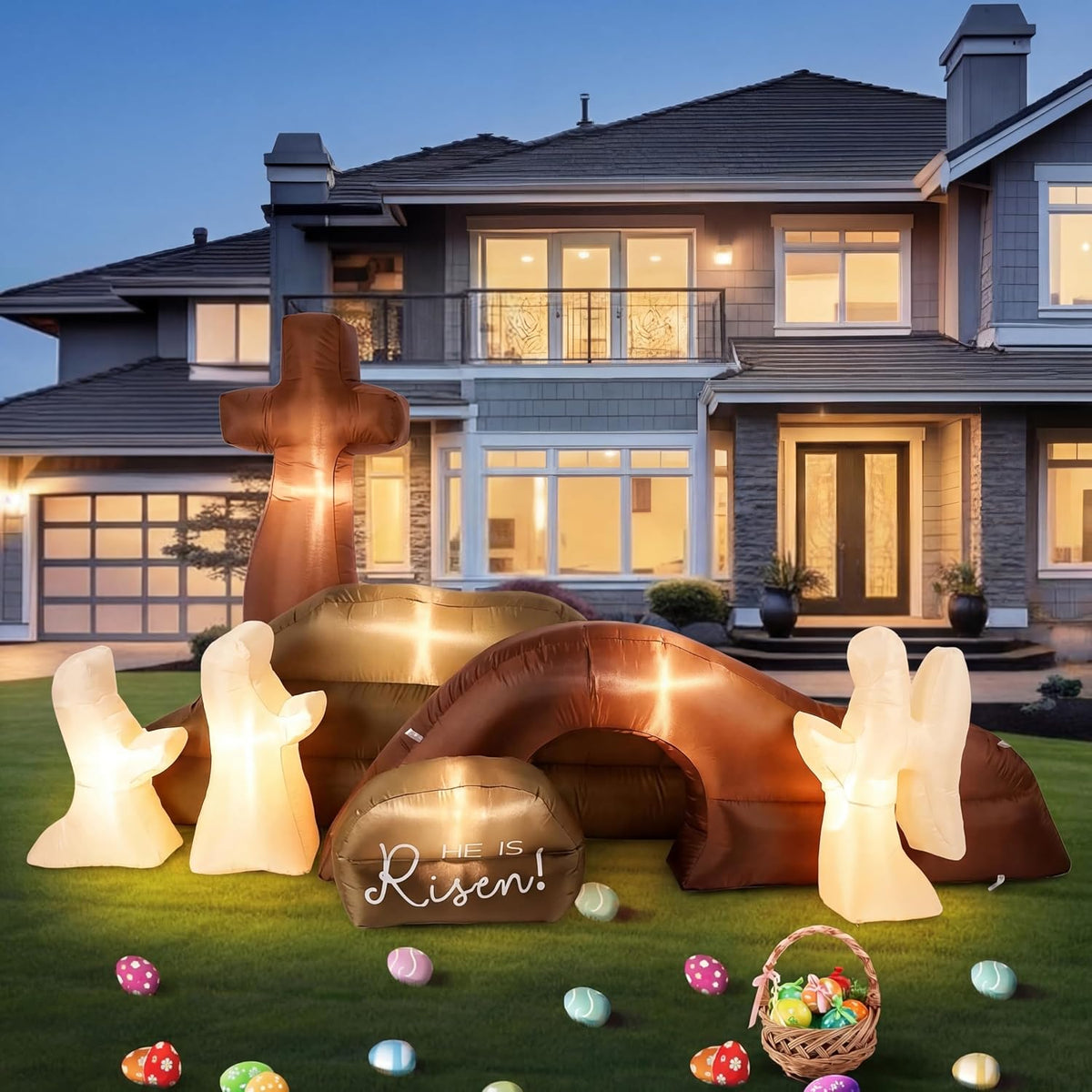 Easter inflatable of the empty tomb with a He Is Risen stone, a cross and white bunnies on a lawn